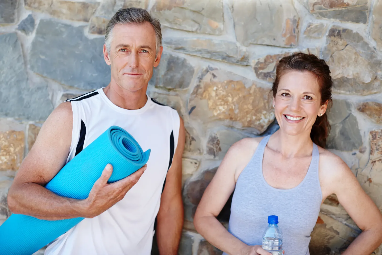 Woman smiling with dumbbells indoors