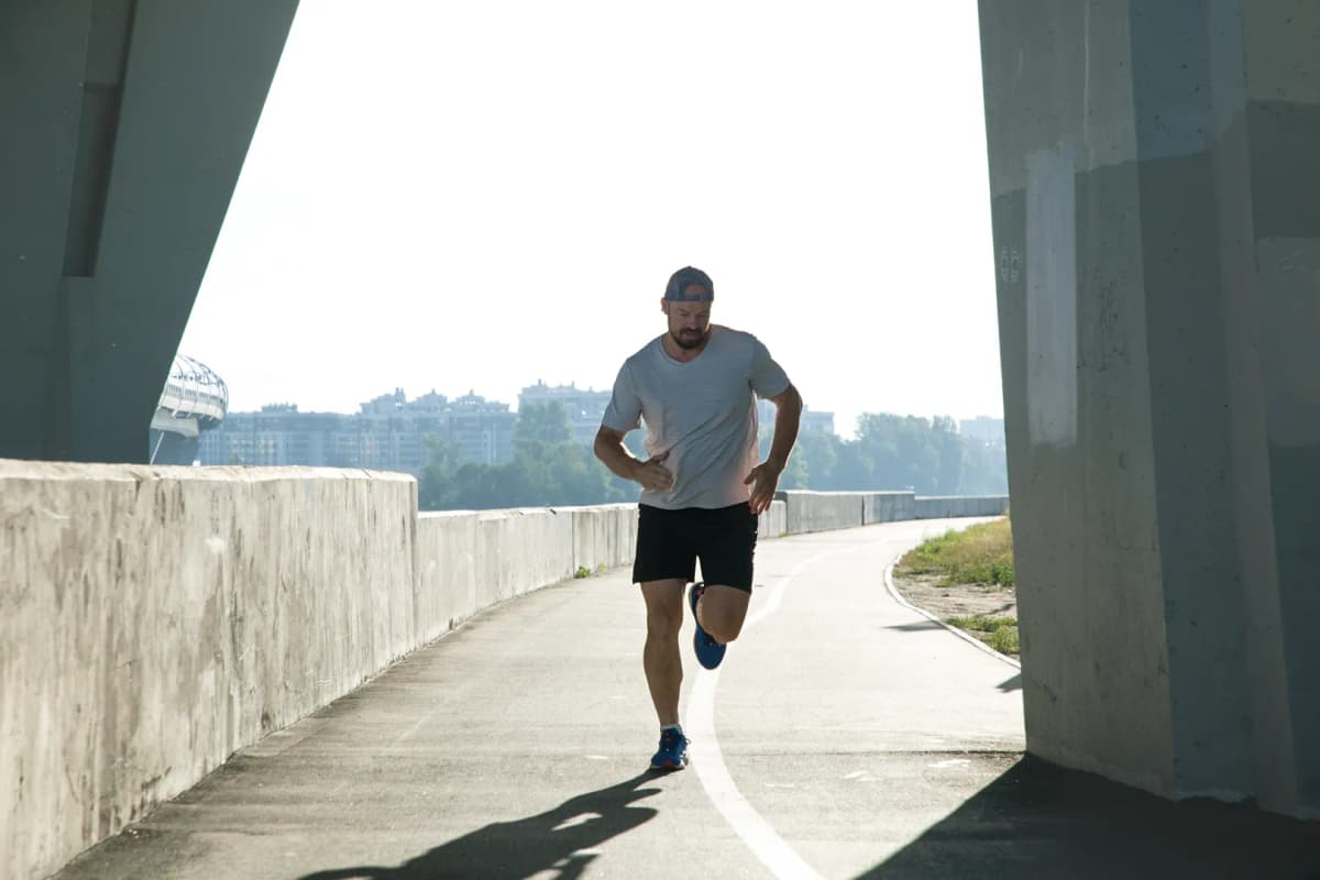 Woman smiling with dumbbells indoors